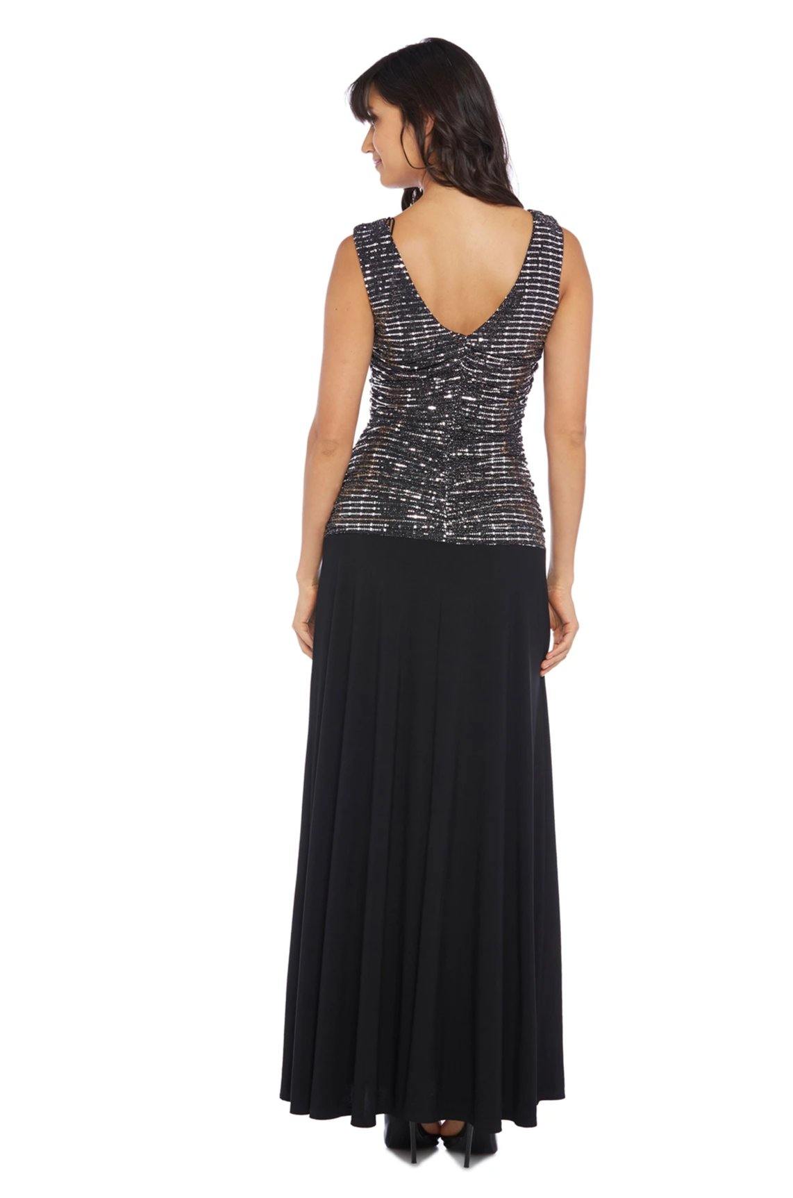 <p class="p1"> </p> <p class="p1">Simple and glamorous top and skirt in one piece. A fitted top covers the curve with a balustrade and a hood made entirely of shiny sequin fabric. A flowing skirt with soft pleats falls to the floor for gentle movements. A V-shaped cut and matching lining flatter the back.</p> <p> </p> <p>Available in <strong><a href="https://%20/products/r-m-richards-long-formal-petite-dress-9159p" title="Petite Size"><span style="text-decoration: underline; color: #00aaff;">Petite Size</span></a></strong></p> <p> </p> <p class="p1"> </p> <p class="p1"><strong>Fabric</strong><span> : Poly Spandex</span></p> <p class="p1"><strong>Length</strong><span> : Full Length</span></p> <p class="p1"><strong>Sleeve Style</strong><span> : Sleeveless</span></p> <p class="p1"><strong>Colors</strong><span> : Navy/Silver, Silver/Black, Steel</span></p> <p class="p1"><strong>Sizes</strong><span> : 6, 8, 10, 12, 14, 16</span></p> <p class="p1"><strong>Fully Lined</strong></p> <p class="p1"><strong>Occasion</strong><span> : Formal, Mother of the Bride, Mother of the Groom, Church, Wedding Guests</span></p>