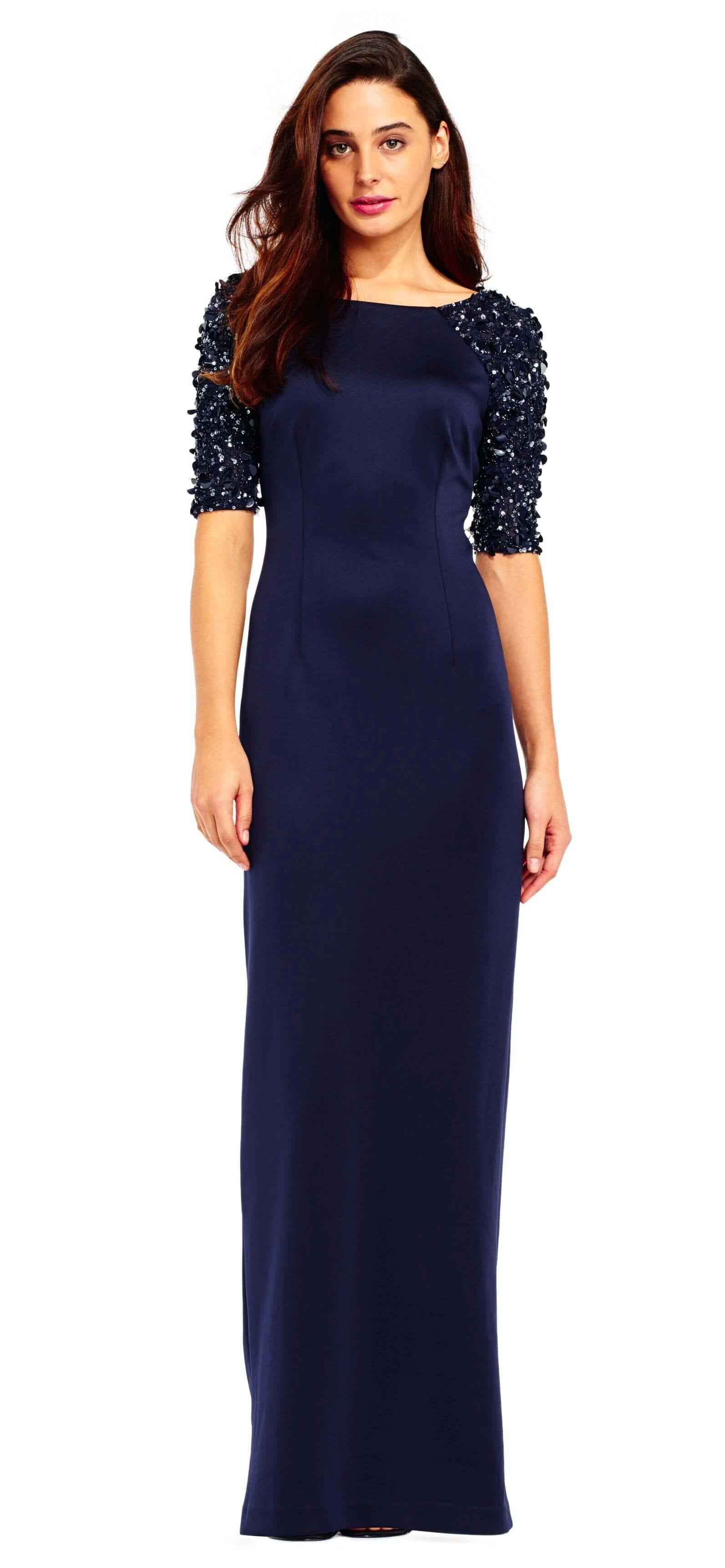 This stunning long dress features a bateau neckline with sequined and embellished quarter length sleeves. The back has a V-shaped cut that connects to the back zipper while the waist is accented with visible seams to show the perfect fit. Perfect for formal, evening party or any special occasion.<br><br><br>Fabric : Sequins, Scuba<br><br>Closure : Zipper Back<br><br>Length : Full Length<br><br>Sleeve Style : 3/4 Sleeve<br><br>Color : Navy<br><br>Sizes : 0, 2, 6<br><br>Fully Lined<br><br>Soft Cup Inserts<br><br>Occasion : Formal, Evening Party, Church, Wedding Guest, Dinner Party, Special Occasion