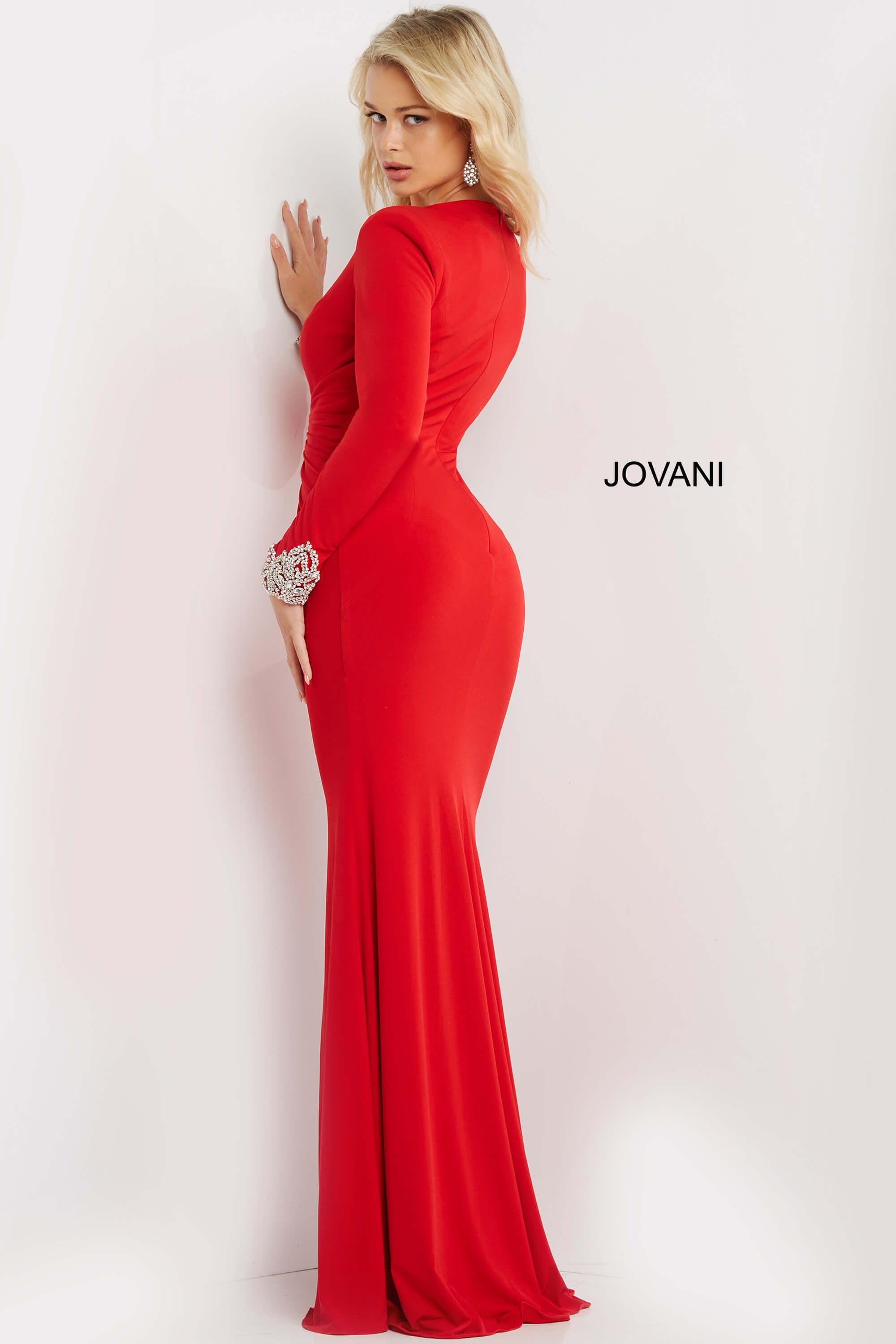 <li>
<strong>Closure: </strong>Invisible Back Zipper with Hook and Eye Closure.</li><li>
<strong>Details: </strong>Stretch jersey bodycon dress, floor length skirt with front slit, ruched bodice with a plunging neckline, long sleeves with embellished cuffs, padded shoulders, close back.</li><li>Available colors: black, red, white</li><li>
<strong>Fabric: </strong>Jersey</li><li>
<strong>Fit: </strong>The Model is 5'9  and Wearing 3  Heels. </li><li>
<strong>Neckline: </strong>low V</li><li>
<strong>Waistline</strong>: Natural</li><li>
<strong>Style: </strong>Jovani Dress 07320</li><li>
<strong>Cleaning: </strong>Spot dry clean only</li><li>
<strong>Collection:</strong> Prom &amp; Evening</li><li>
<strong>Fabric:</strong> Jersey</li><li>
<strong>Style: </strong>Column, Fitted</li><li>
<strong>Details:</strong> Ruched</li><li>
<strong>Length:</strong> Long Dress</li><li>
<strong>Back Style: </strong>Closed Back with Zipper</li><li>
<strong>Necklines: </strong>V-Neckline</li><li>
<strong>Sleeve Type:</strong> Long</li>