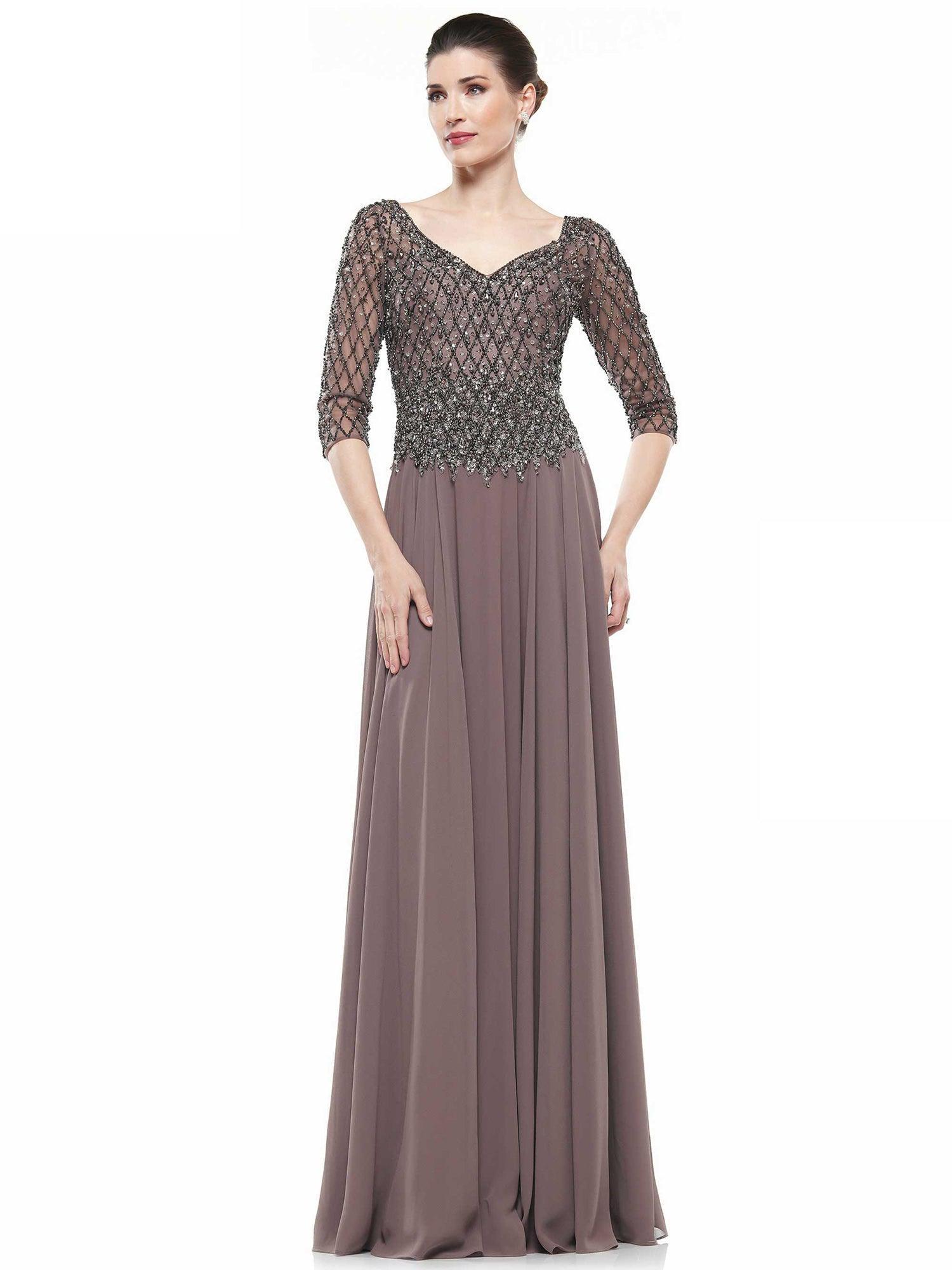 <p>Welcome to a world of luxury and elegance with the <strong>Marsoni Long Formal Mother of the Bride Dress Sale</strong>! Introducing this exquisite gown created especially for the mother of the bride to make you shine at your wedding ceremony and remain an unforgettable memory.</p>
<p>This dress is the perfect option for special occasions. It is made of delicate and graceful chiffon, which gives it a lightness and fluidity. The gorgeous texture of the fabric makes this dress truly unique and attractive.</p>
<p>The features of this dress are its 3/4 sleeves, which give it a classic and elegant look. They frame your figure and accentuate your femininity, creating a gorgeous look.</p>
<p>All Sale Items are Final Sale</p>
<p>Fabric : Chiffon</p>
<p>Zipper Back</p>
<p>Length : Full Length</p>
<p>Sleeve Style : 3/4 Sleeve</p>
<p>Colors : Dark Taupe, Silver, Slate Blue, Dark Plum, Navy, Charcoal Grey</p>
<p>Sizes : 6, 8, 10, 12, 14, 16, 18, 20, 22, 24</p>
<p>Fully Lined</p>
<p>Occasion : Formal, Evening Party, Church, Wedding Guest, Mother of the Bride, Mother of the Groom</p>