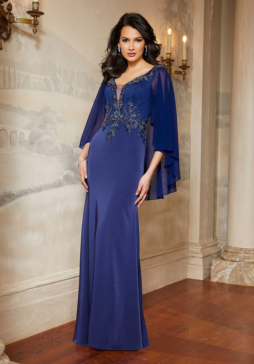 <p> </p> <p>This gorgeous long dress features<span> a plunging neckline, a zipped-up back and removable chiffon cape sleeves. This fit and flare evening dress is designed in stretch crepe and finishes in a sweep train. </span>This dress is perfect for any special occasion.</p> <p> </p> <p> </p> <p>Length : Full Length</p> <p>Sleeve Style : 3/4 Sleeves</p> <p>Color : Sapphire, Dusty Rose</p> <p>Sizes : 2, 4, 6, 8, 10, 12, 14, 16, 18, 20</p> <p>Fully Lined</p> <p>Soft Cup Inserts</p> <p>Occasion : Formal, Prom, Homecoming, Wedding Guest, Evening Party, Red Carpet, Pageant, Special Occasion</p> <p> </p>