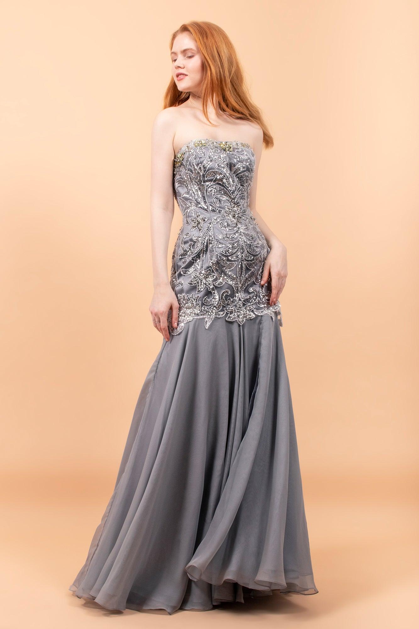 <p>The chiffon fabric is sure to make you feel elegant, while still maintaining comfort throughout any event. It has strapless straight across neckline with beaded bodice and sexy high slit. This stylish, versatile dress is just what you need. <br><br><br>Fabric : Chiffon<br><br>Zipper Back<br><br>Length : Full Length<br><br>Sleeve Style : Strapless<br><br>Color : Silver<br><br>Sizes : S, M, L, XL<br><br>Fully Lined<br><br>Occasion : Prom, Formal, Evening Party, Homecoming, Wedding Guest, Red Carpet, Pageant</p>