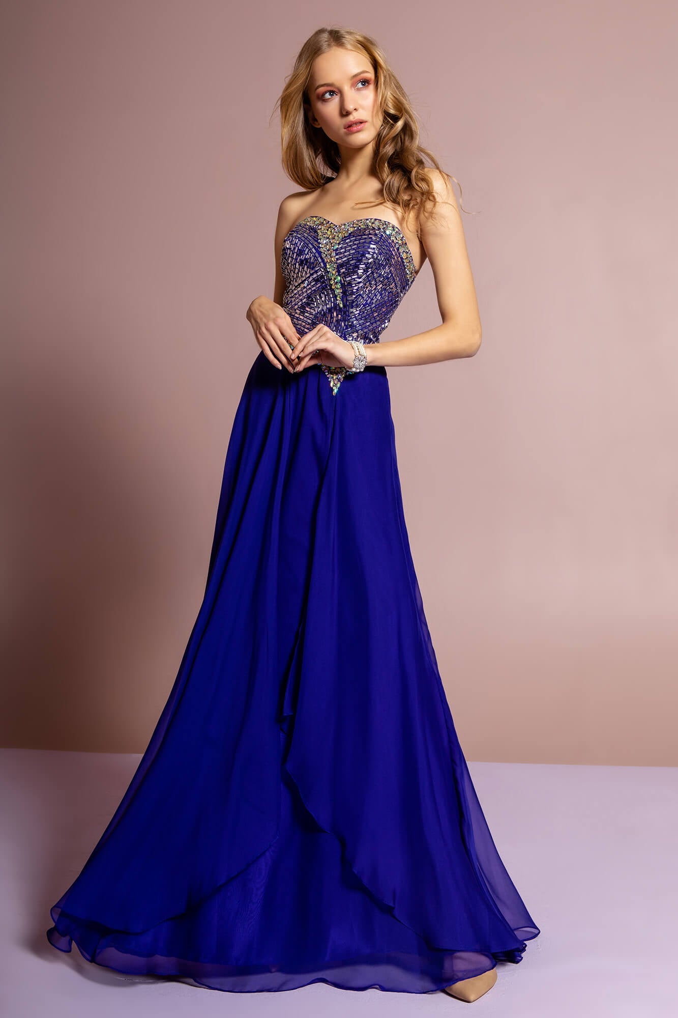 This dress features a strapless sweetheart neckline with beads and jewels on a fitted bodice and a semi-open back. Ornamented at the waist with an asymmetrical bejeweled band. A-Line skirt flows down to a full-length hem. Perfect for formal, evening party or any special occasion.<br><br><br>Fabric : Chiffon<br><br>Closure : Zipper Back<br><br>Length : Full Length<br><br>Sleeve Style : Strapless<br><br>Colors : Royal Blue, Fuchsia, Off White<br><br>Sizes : XS, S, M, L, XL, 2XL<br><br>Fully Lined<br><br>Soft Cup Inserts<br><br>Occasion : Formal, Prom, Homecoming, Wedding Guest, Evening Party, Red Carpet, Pageant, Special Occasion 