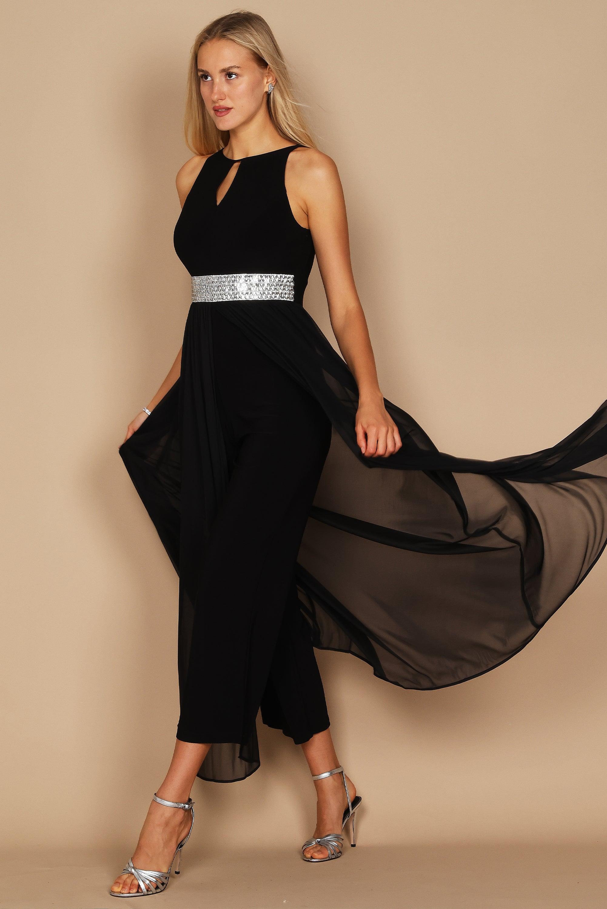 <p>This elegant jumpsuit features a halter neckline with a rhinestone detail on the waistline<span data-mce-fragment="1">. This dress is perfect for any special occasion.</span></p> <p> </p> <p> </p> <p>Available in <strong><a href="https://%20/products/r-m-richards-long-plus-size-formal-jumpsuit-5375w" title="Plus Size"><span style="text-decoration: underline; color: #99cce6;" ne="0.9024372321727685">Plus Size</span></a> and <strong><a href="https://%20/products/r-m-richards-long-formal-petite-jumpsuit-5375p" title="Petite Size"><span style="text-decoration: underline; color: #99cce6;" ne="0.447438742782025">Petite Size</span></a> <br> </strong></strong></p> <p> </p> <p><br></p> <p><strong>Fabric</strong><span> </span>: Polyester</p> <p><strong>Length</strong><span> </span>: Full Length</p> <p><strong>Sleeve Style</strong><span> </span>: Halter</p> <p><strong>Colors</strong><span> </span>: Navy, Black</p> <p><strong>Sizes</strong><span> </span>: 6, 8, 10, 12, 14, 16</p> <p><strong>Fully Lined</strong></p> <p><strong>Soft Cup Inserts</strong></p> <p><strong>Occasion</strong><span> </span>: Formal, Evening Party, Mother of the Bride, Mother of the Groom, Church, Wedding Guest</p>