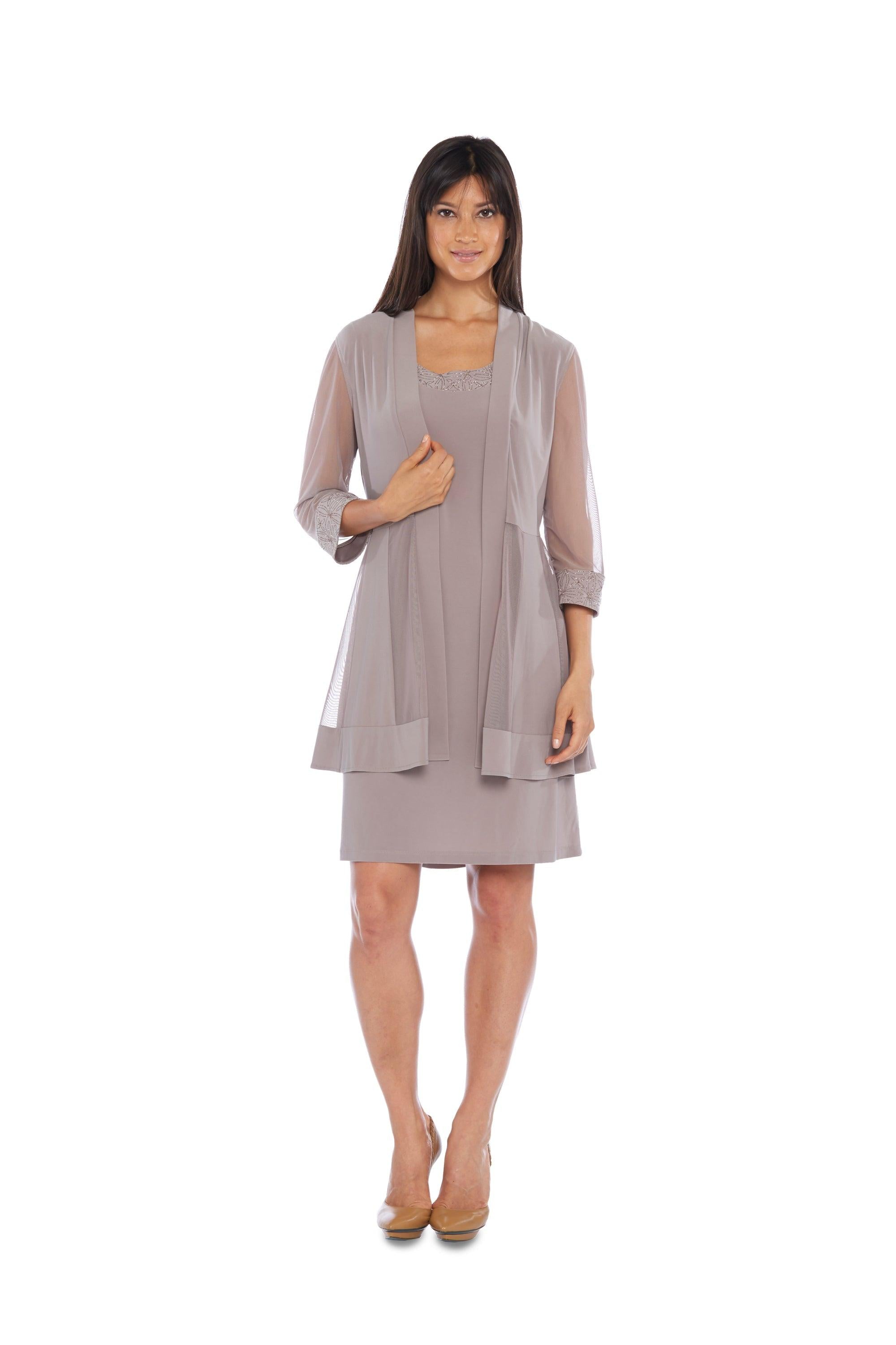 <span data-mce-fragment="1">This elegant short mother of the bride/groom dress features a scoop neck and Sheer sleeves on the jacket, constructed of spandex and polyester. This dress is perfect for church, wedding or any special occasion.</span> <p> </p> <p> </p> <p>Available in <strong><a title="Regular Size" href="https://%20/products/r-m-richards-short-mother-of-the-bride-dress-8271"><span style="text-decoration: underline; color: #00aaff;">Regular Size </span></a> and <strong><a title="Plus Size" href="https://%20/products/r-m-richards-short-mother-of-the-bride-plus-size-jacket-dress"><span style="text-decoration: underline; color: #00aaff;">Plus Size</span></a> </strong></strong><br></p> <br data-mce-fragment="1"><br data-mce-fragment="1"><strong data-mce-fragment="1">Fabric</strong><span data-mce-fragment="1"> : Poly Spandex</span><br data-mce-fragment="1"><br data-mce-fragment="1"><strong data-mce-fragment="1">Sleeve Style</strong><span data-mce-fragment="1"> : Sleeveless with Matching Jacket</span><br data-mce-fragment="1"><br data-mce-fragment="1"><strong data-mce-fragment="1">Length</strong><span data-mce-fragment="1"> : 44 inches</span><br data-mce-fragment="1"><br data-mce-fragment="1"><strong data-mce-fragment="1">Colors</strong><span data-mce-fragment="1"> : Red, Peacock, Navy, Royal Blue, Hunter, Taupe, Slate, Lavender</span><br data-mce-fragment="1"><br data-mce-fragment="1"><strong data-mce-fragment="1">Sizes</strong><span data-mce-fragment="1"> : PS, PM, PL, PXL</span><br data-mce-fragment="1"><br data-mce-fragment="1"><strong data-mce-fragment="1">Fully Lined</strong><br data-mce-fragment="1"><br data-mce-fragment="1"><strong data-mce-fragment="1">Occasion</strong><span data-mce-fragment="1"> : Formal, Cocktail, Wedding, Mother of the Bride, Mother of the Groom, Funeral, Church, Wedding Guests</span><br>