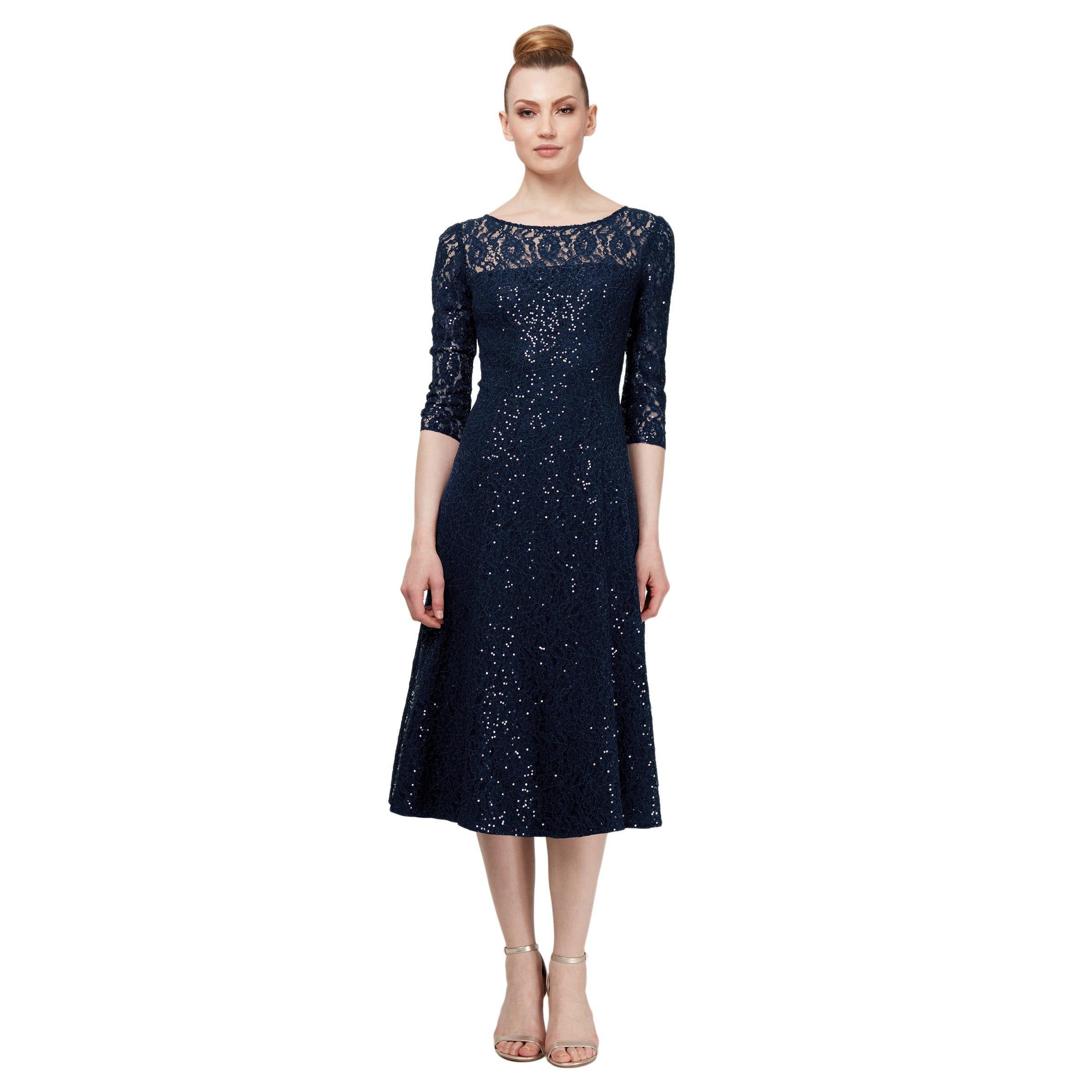 This classic and elegant lace dress with sequins in different sequins on lace and top vest with illusion and 3/4 sleeves, tulle skirt and a back keyhole. Perfect for any special occasion.<br data-mce-fragment="1"><br data-mce-fragment="1"><br data-mce-fragment="1"><br data-mce-fragment="1">Fabric : Sequined Lace<br data-mce-fragment="1"><br data-mce-fragment="1">Closure : Zipper Back<br data-mce-fragment="1"><br data-mce-fragment="1">Length : Midi Length<br data-mce-fragment="1"><br data-mce-fragment="1">Sleeve Style : 3/4 Sleeve<br data-mce-fragment="1"><br data-mce-fragment="1">Colors : Navy, Black<br data-mce-fragment="1"><br data-mce-fragment="1">Sizes : 6, 8, 10, 12, 14, 16, 18<br data-mce-fragment="1"><br data-mce-fragment="1">Fully Lined<br data-mce-fragment="1"><br data-mce-fragment="1">Occasion : Short Cocktail, Mother of the Bride, Mother of the Groom, Church, Wedding Guests