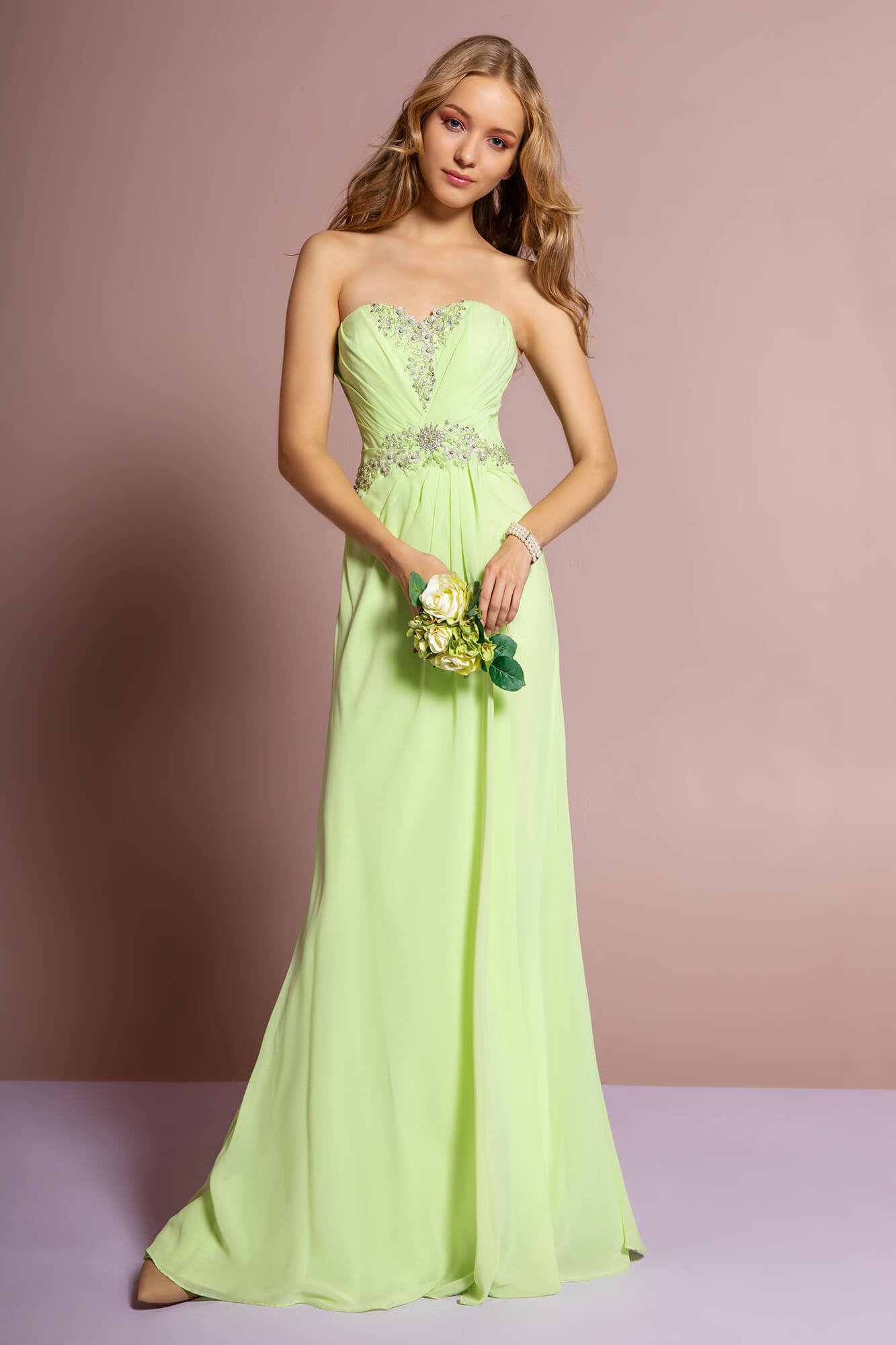 <p><br><span>This strapless dress is detailed with crystal beads highlighting the pleated sweetheart bodice. Soft pleats gathers at the center waist and reveals a soft flowing A-line skirt with movement and a full length hem.</span></p> <p> </p> <p>Fabric : Chiffon<br><br>Closure : Corset Back<br><br>Sleeve Style : Strapless<br><br>Colors : Light Green, Pink<br> <br>Sizes : XS, S, M, L, XL, 2XL, 3XL<br><br>Fully Lined<br><br>Occasion : Formal, Prom, Homecoming, Special Occasion</p> 