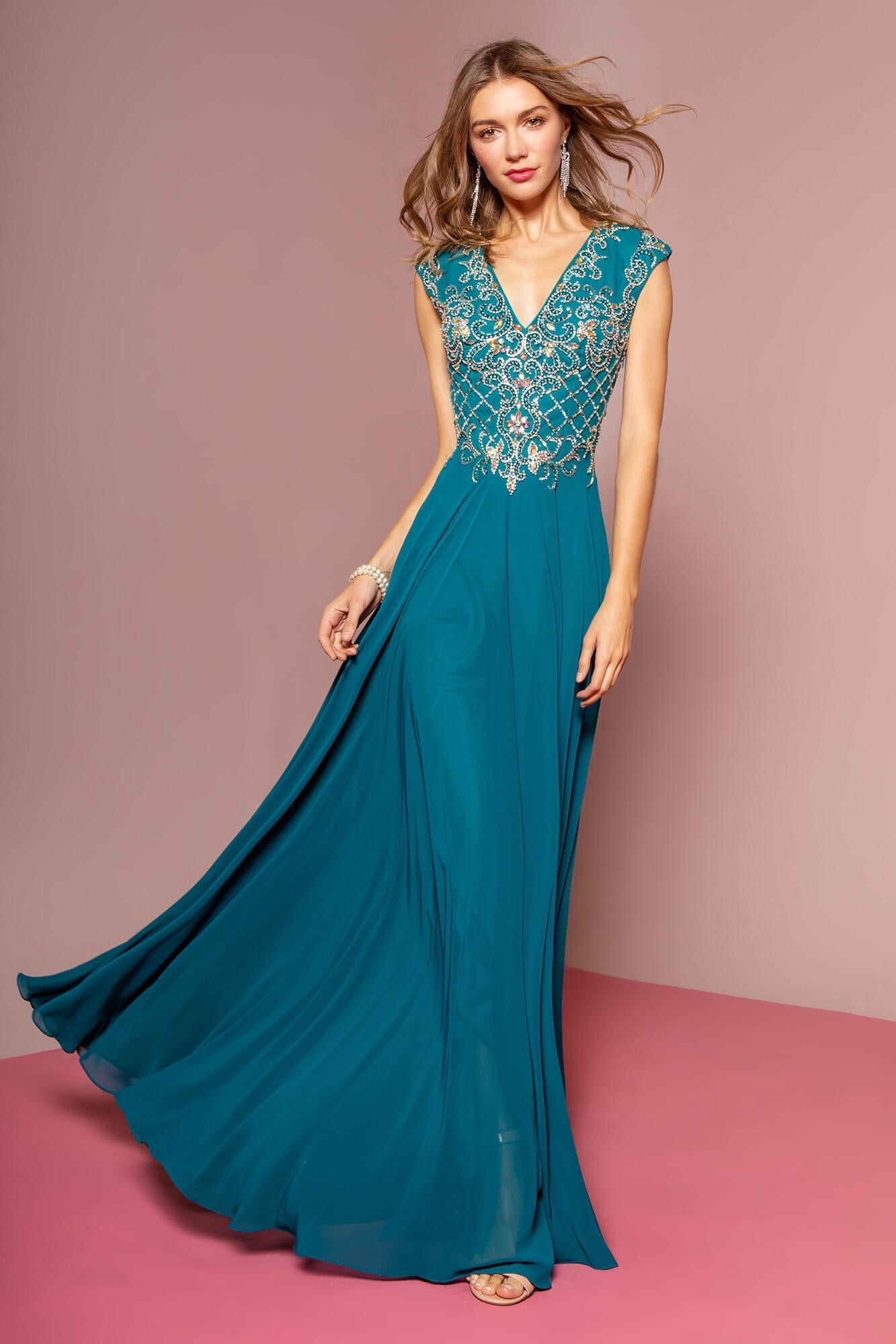 <p><br><span>V-neckline with diamond cut out detail at the back fashions a lovely silhouette. The fitted bodice will highlight your curves in sparkling beaded embellishments in all the right places. This deluxe ensemble glides to the floor length hem in a picture perfect red carpet look.</span></p> <p> </p> <p><span>Fabric : Chiffon<br><br>Closure : Open Back<br><br>Sleeve Style : Cap Sleeve<br><br>Colors : Teal, Tan<br><br>Sizes : XS, S, M, L, XL, 2XL, 3XL<br><br>Fully Lined<br><br>Occasion : Formal, Prom, Homecoming, Special Occasion</span></p> 